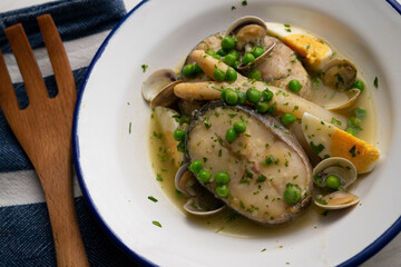 Basque hake with green sauce, asparagus, eggs and peas. Traditional Basque country tapas in the north of Spain.