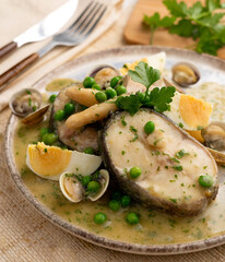Basque hake with green sauce, asparagus, eggs and peas. Traditional Basque country tapas in the north of Spain.