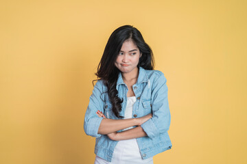 young woman stand cross hand with unhappy sad face on isolated background