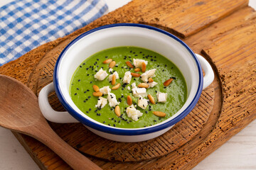Spinach and peas cream with goat cheese and pine nuts.