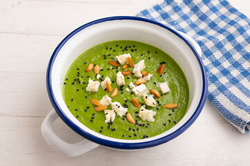 Spinach and peas cream with goat cheese and pine nuts.