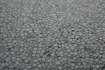 Texture of grey styrofoam sheet as background, closeup