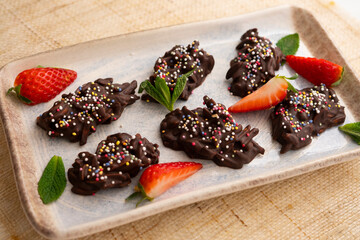 Chocolate rocks and almonds with caramel. Traditional Barcelona dessert.