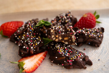 Chocolate rocks and almonds with caramel. Traditional Barcelona dessert.