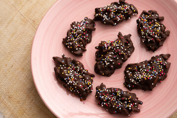Chocolate rocks and almonds with caramel. Traditional Barcelona dessert.