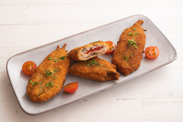 Anchovies stuffed with peppers and cheese, battered and fried. Traditional tapas from the south of Spain.