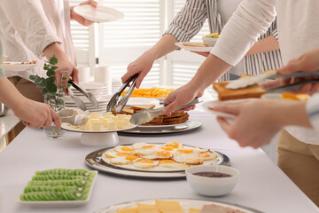 People taking food during breakfast, closeup. Buffet service