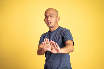 bald man rejecting offer with both palms on isolated background