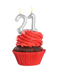 Delicious cupcake with number shaped candles on white background. Coming of age party - 21th birthday