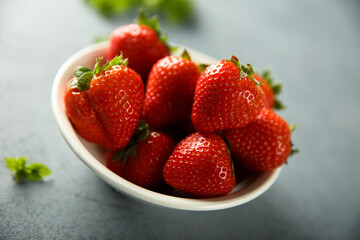 Fresh ripe strawberry in a white bowl