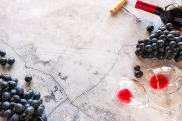 red wine, glasses and grapes on a marble background with space for text