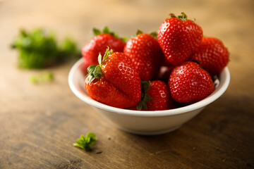 Fresh ripe strawberry in a white bowl