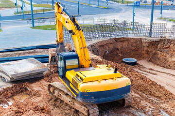 Powerful excavator work on a construction site, sunny blue sky in the background. Construction...
