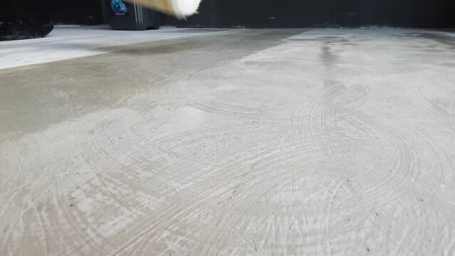 The process of priming the floor with a roller
