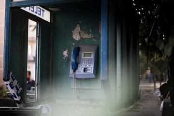 Old blue telephone booth with numbers with cinematic light in Istanbul