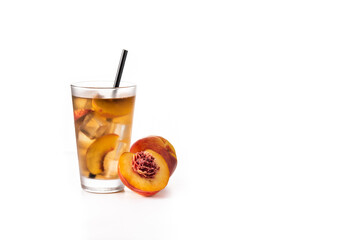 Glass of peach tea with ice cubes isolated on white background. Copy space