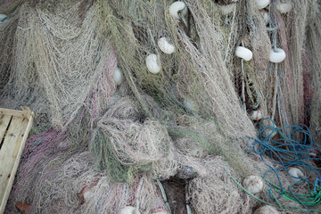 Stacked fishing nets and ropes red, green, blue and white