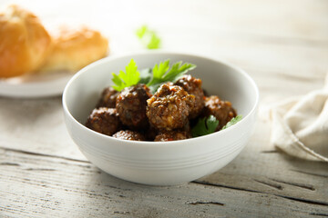 Homemade meatballs in a white bowl