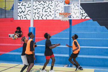 African friends playing basketball outdoor - Focus on faces