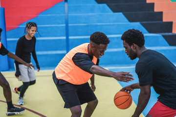 Naklejka premium African friends playing basketball outdoor - Focus on right man face