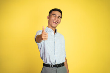asian young businessman showing thumbs up with smiling teeth on isolated background