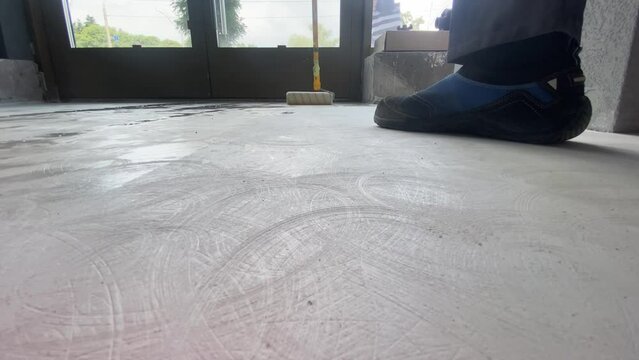 The process of priming the floor with a roller