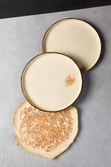 Ceramic dishware in modern style on gray stone background. Empty Handmade crockery in minimalistic composition. Pottery plate on concrete background.