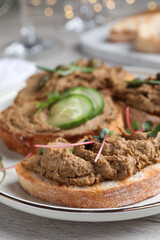 Slices of bread with delicious pate on white wooden table, closeup