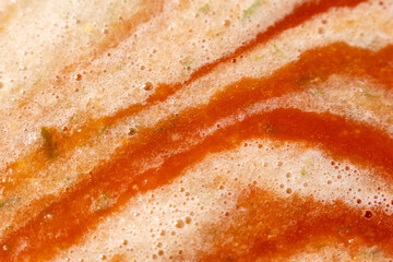 Naklejka premium Tomato vegetable sauce boiling in saucepan in the process of cooking. Selective focus