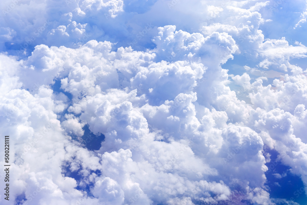 Wall mural white fluffy clouds below. top view from the window of an airplane flying in the clouds. selective f