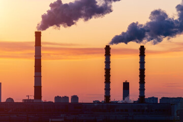 Factory pipes thermal power plants with thick white smoke from heat energy nuclear plant polluting environment. Selective focus