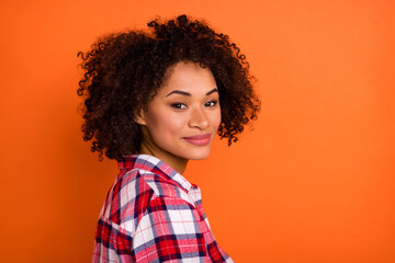 Photo of charming adorable young woman wear plaid shirt smiling isolated orange color background