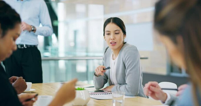 Shes young and ambitious. 4k video footage of an attractive young businesswoman sitting in the boardroom during a meeting.