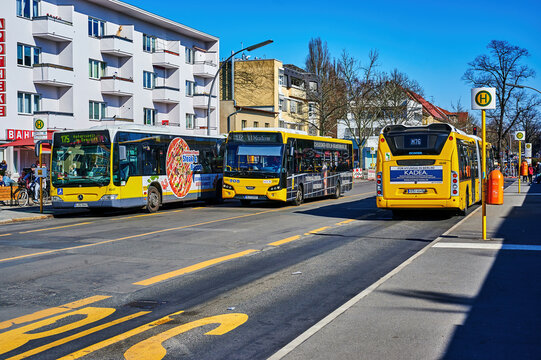 Berlin, Germany - March 22, 2022: Street scene at a bus stop in a small shopping street in Lichtenrade on the outskirts of Berlin, Germany.