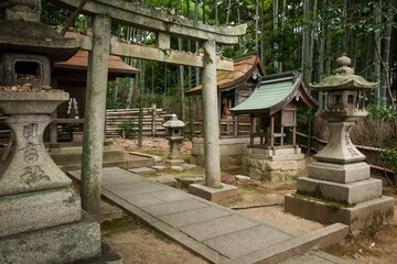 Stone toriis and lanterns in a Shinto shrine in Shoren-in Buddhist Temple (Shoren-in Monzeki) exterior, Kyoto
