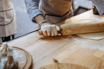 Cooking Georgian dish khinkali with dough and meat