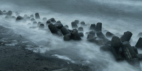 Tetrapods protecting coastline of a Baltic sea during the storm shot with long exposure. Good for wallpaper or a poster.