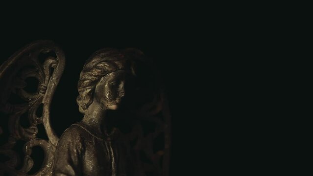 footage of angel statue dark background