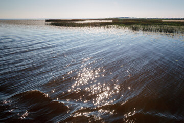 The shallow water of the lagoon glowing in the sun at noon.