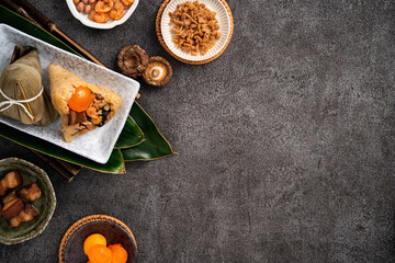 Zongzi. Rice dumpling for Dragon Boat Festival on dark gray table background with ingredient.