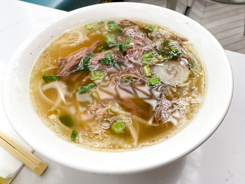 A bowl of beef brisket pho, a Vietnamese dish with meet, noodles and broth.