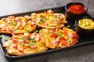 Tasty fritters with ham and vegetables close-up on a plate on the table. horizontal