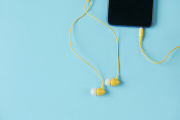 smart phone and headphone on wooden background .