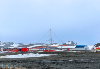 Antarctica base camp and radio tower with snow ground and mountain