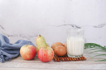 glass of milk, egg, and apple for morning breakfast 
