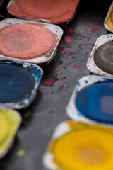 Close-up macro shot of beautiful vibrant watercolour pallete with plenty of texture and details