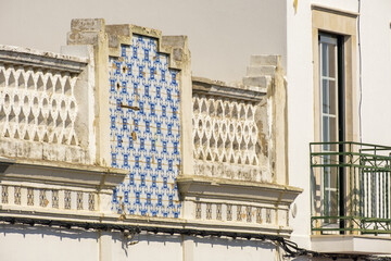 Old azulejos tiles on a facade in the village of Estoi, Algarve, Portugal