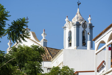 Obraz premium bell tower of Portuguese Church landmark Igreja de Sao Martinho de Estoi as known as Matriz de Estoi, Faro, Algarve, Portugal