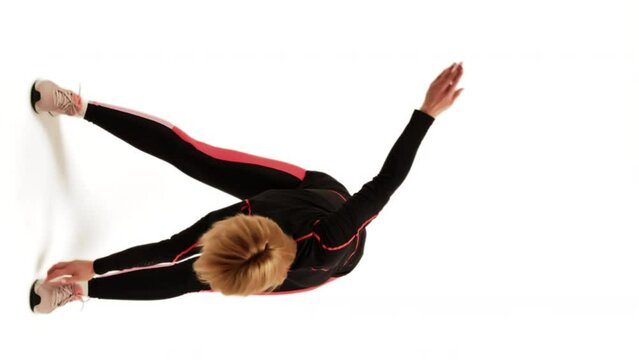 Toe Touch Crossover Exercise. Woman Bending Over Swing In Rotation Warm-up. Vertical Video.