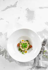 Original russian potato salad with green peas and mayonnaise. Russian christmas menu. Olivier salad with boiled potatoes, carrots, eggs, peas and meat with mayo dressing.  Traditional New year dish.